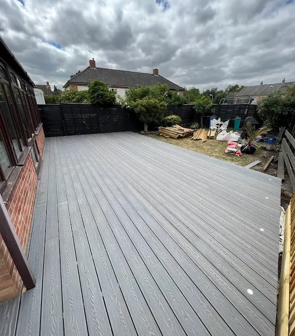 image of finished grey modern decking in garden with clouds in the background