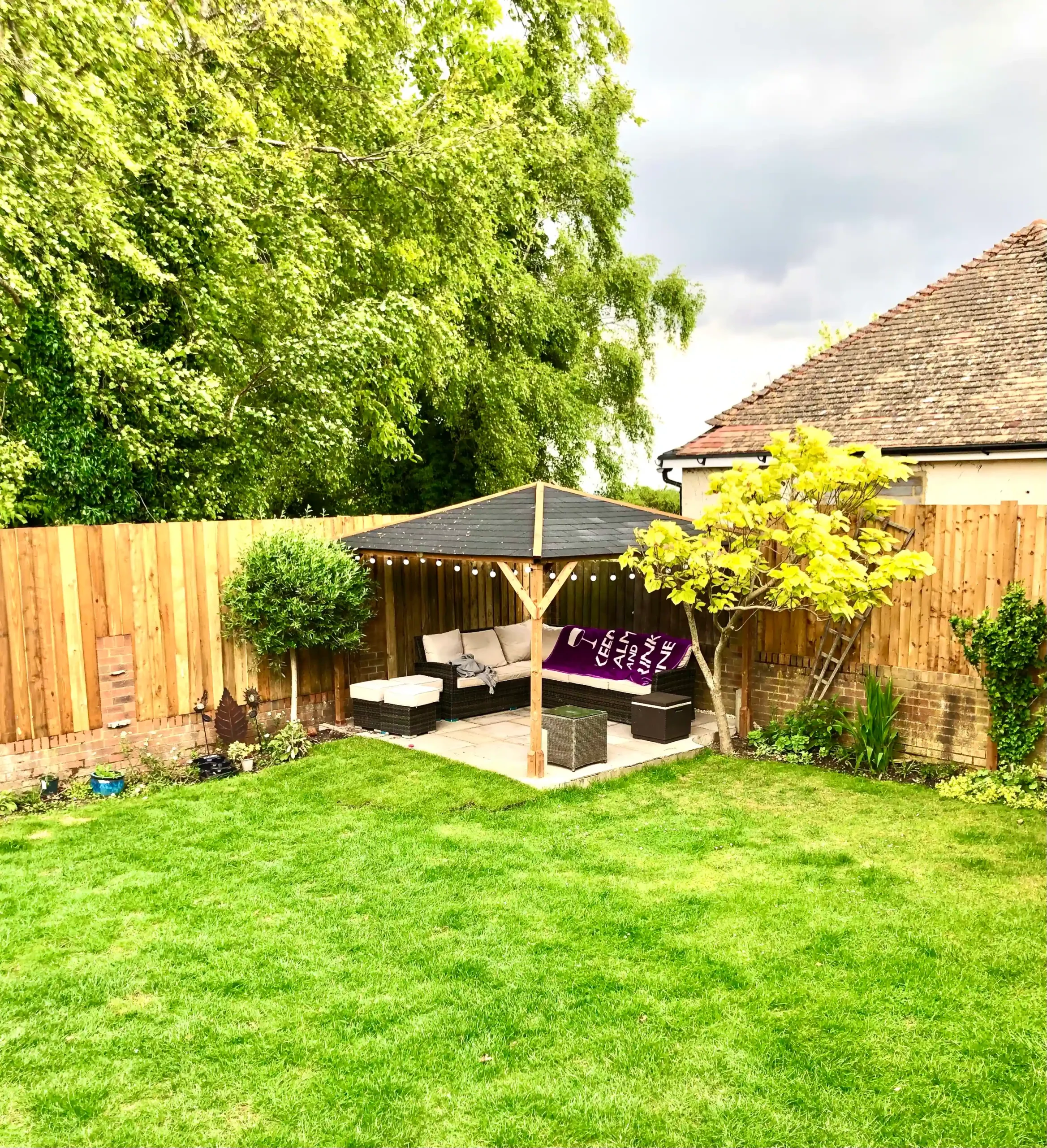 new indian sandstone patio at bottom of garden with gazebo