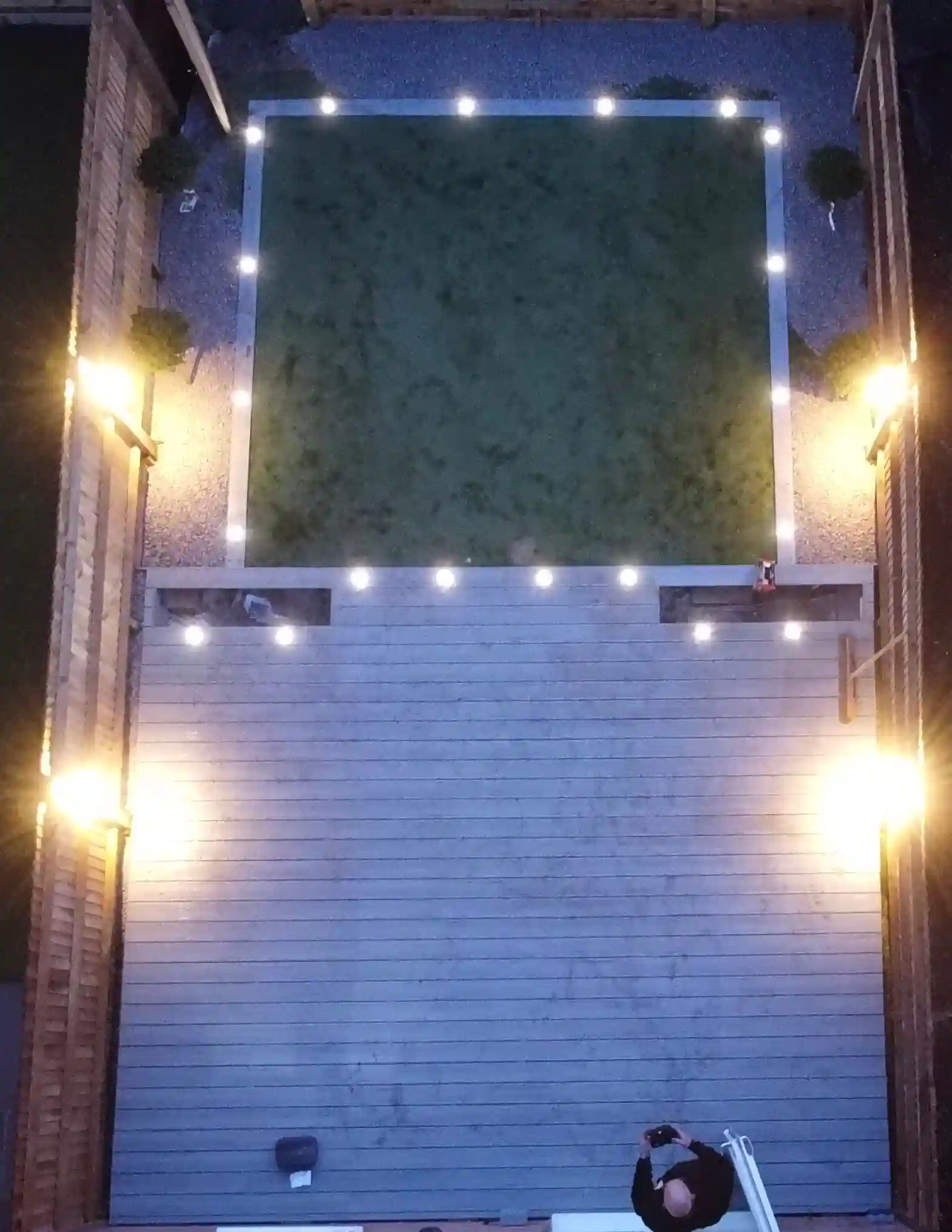 birds eye view of transformed garden with decking border with lights