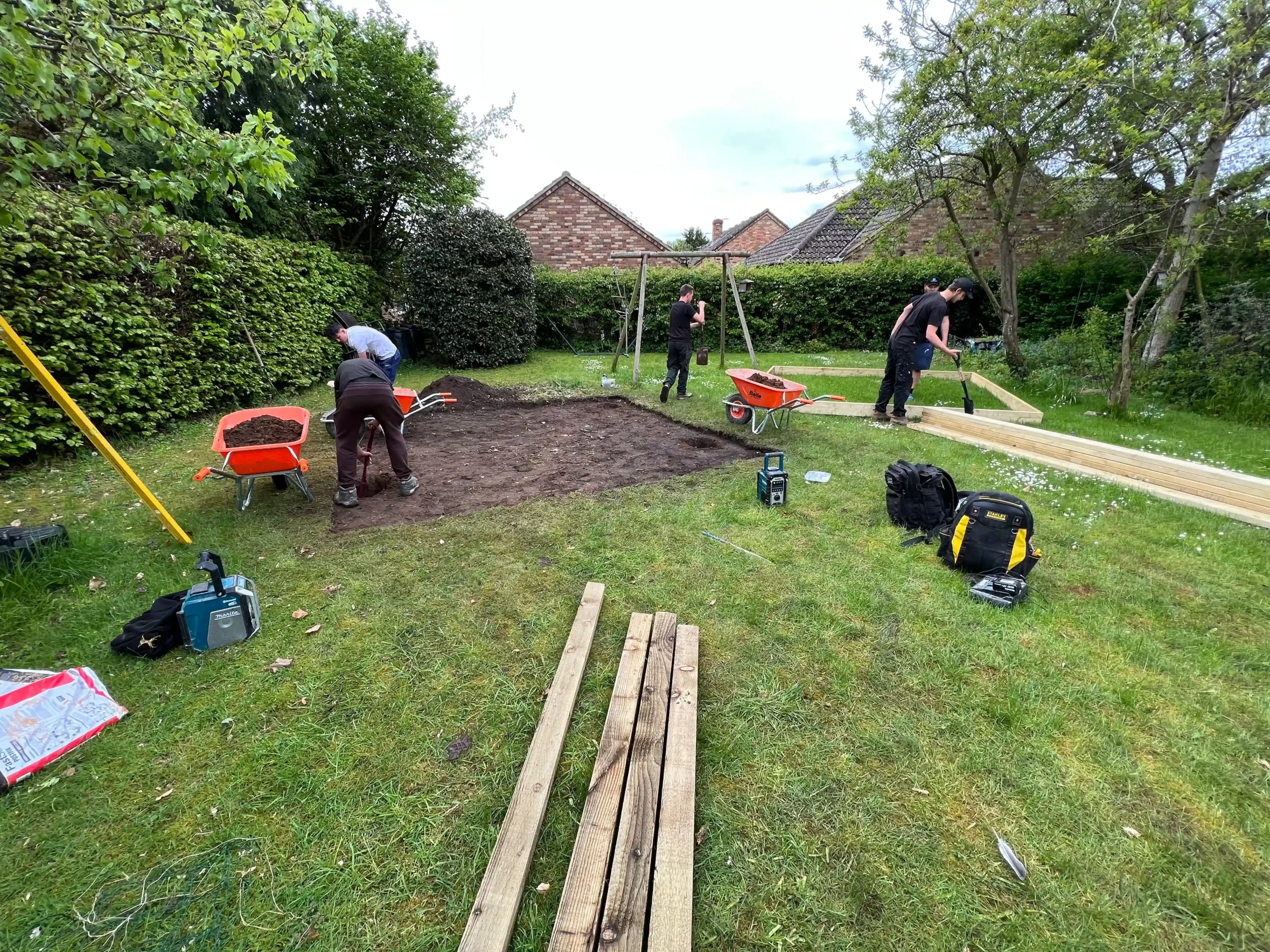 Before image of garden transformation with wooden timbers and barked areas
