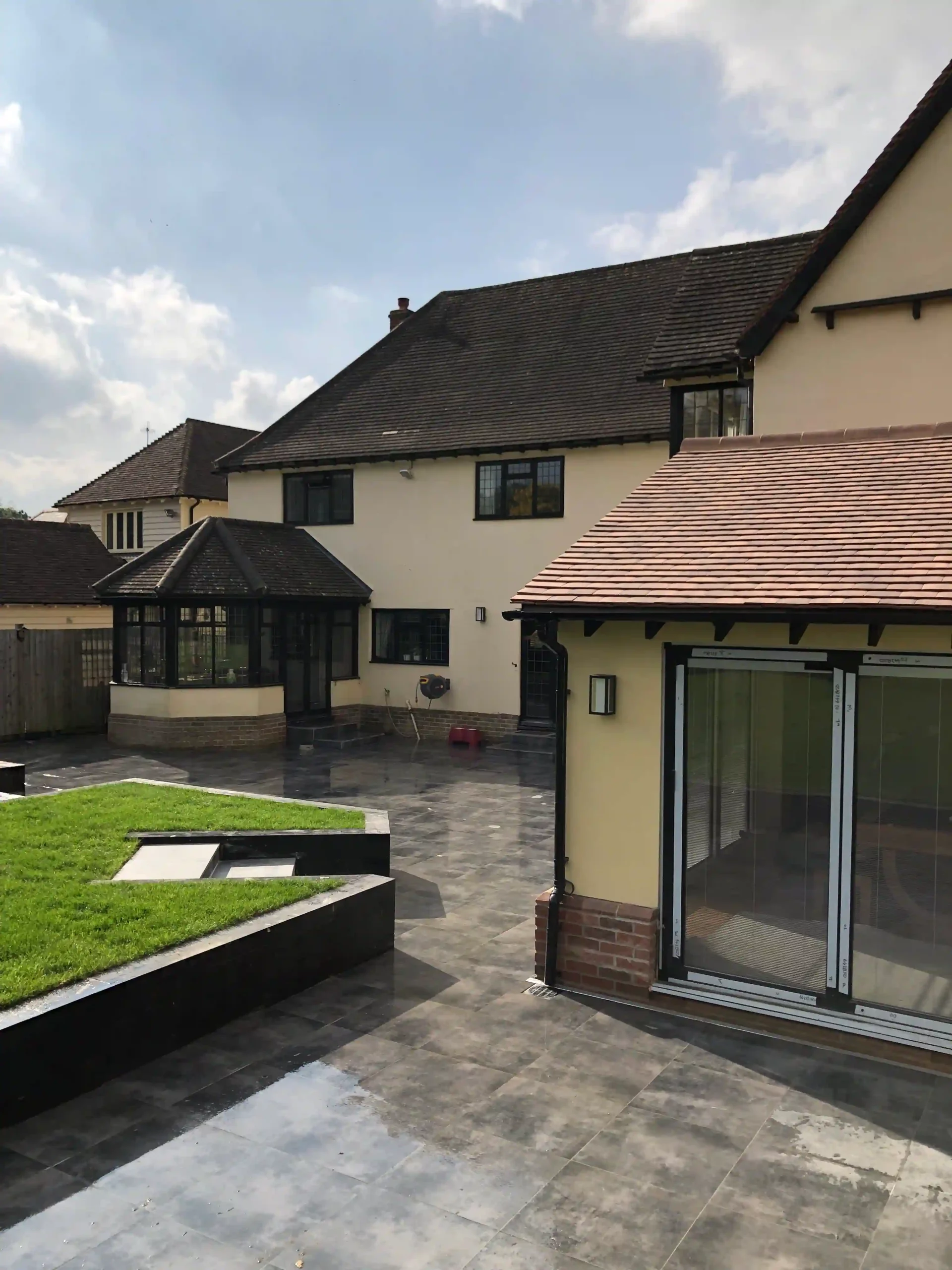 Finished garden transformation with porcelain patio with gully drains and sleeper walls